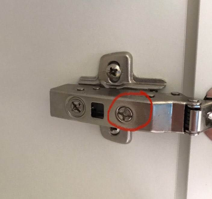 Adjusting shop cupboard hinges